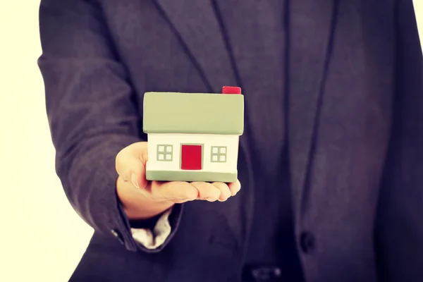 Businesswoman with house model. — Stock Photo, Image