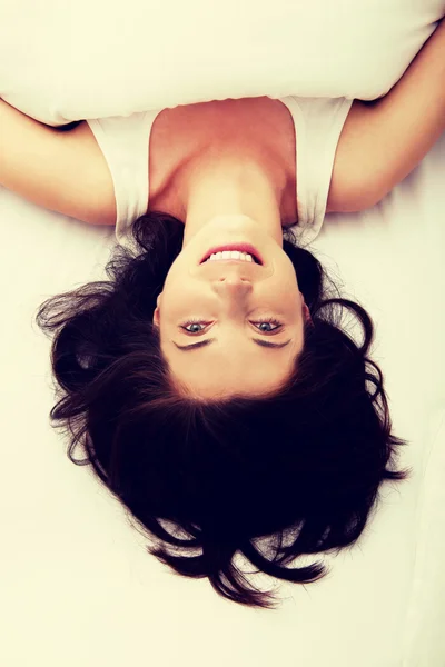 Happy woman lying in bed. — Stock Photo, Image