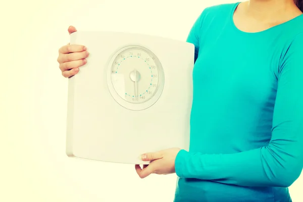 Teenager holding a scale. — Stock Photo, Image