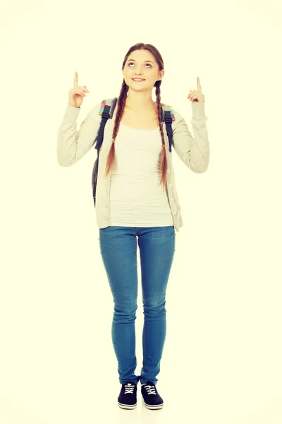 Schoolgirl pointing up. — Stock Photo, Image