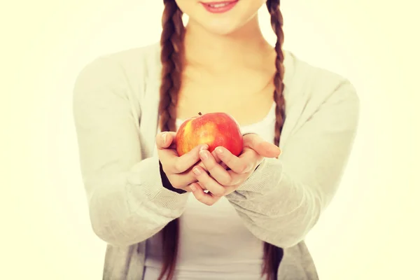 Teenage woman holding an apple. — Stock Photo, Image