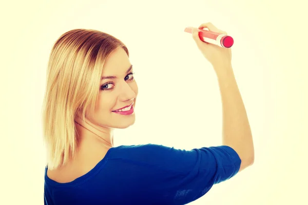 Woman writing with oversized pencil. — Stock Photo, Image