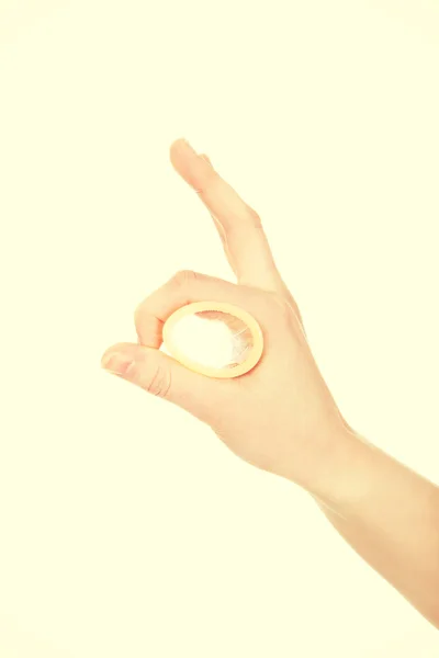 Woman hand holding a condom. — Stock Photo, Image