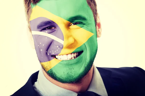 Hombre feliz con bandera de Brasil en la cara . — Foto de Stock