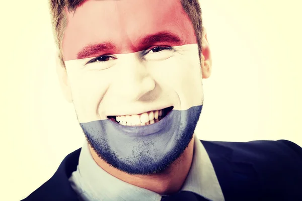 Happy man with Netherlands flag on face. — Stock Photo, Image