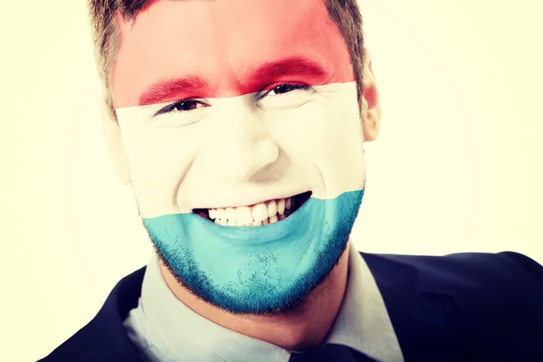 Luksemburg zászló arcán boldog ember. — Stock Fotó