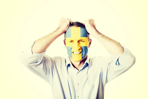 Mature man with Sweden flag on face. — Stock Photo, Image