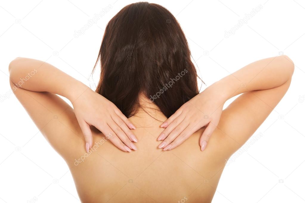 Beautiful woman touching her back.