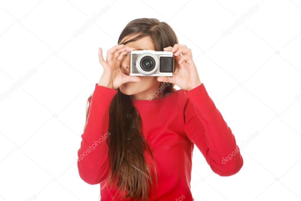 Woman taking a photo with a camera.