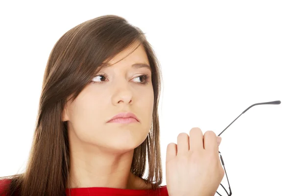 Thoughtful woman holding glasses. — Stock Photo, Image