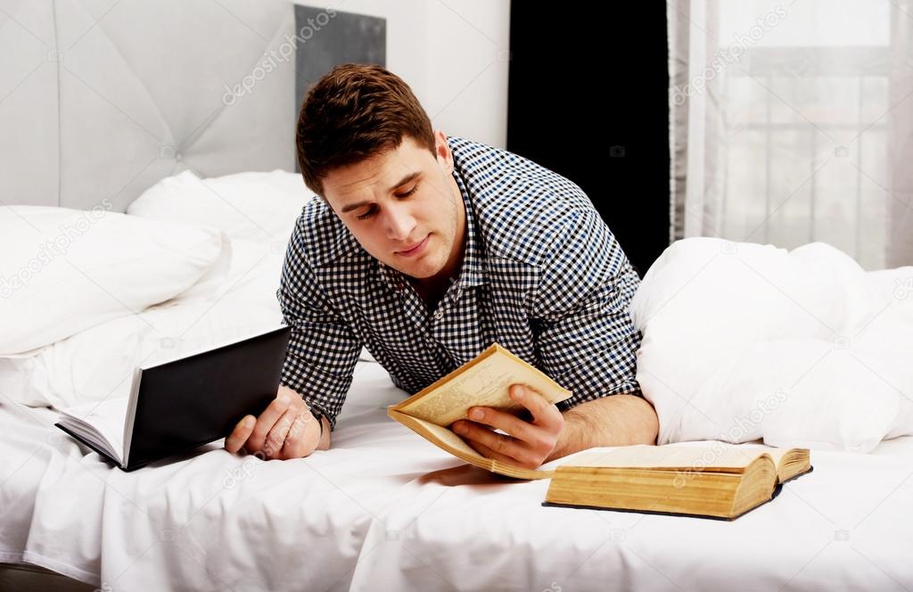 Thoughtful man with a book in his bed.