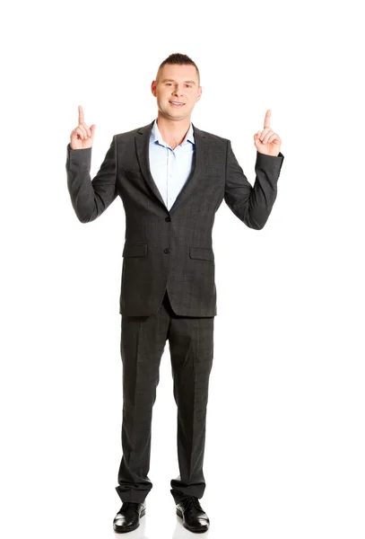 Young businessman pointing upwards — Stock Photo, Image