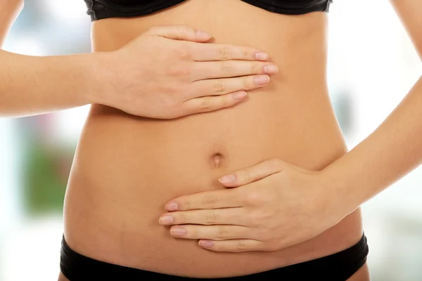 Woman touching her belly. — Stock Photo, Image
