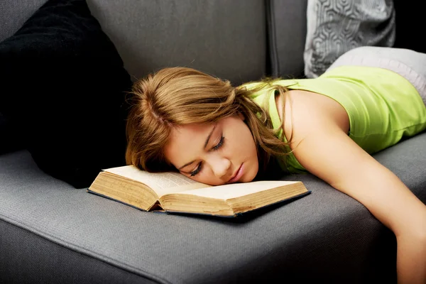 Tired woman with her head on book. — Stock Photo, Image