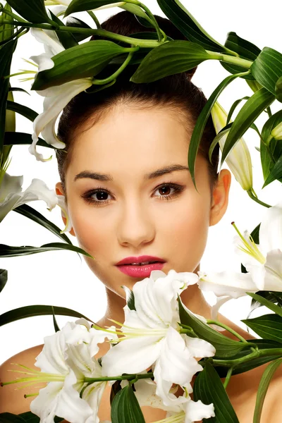 Beauty face of a woman with flowers. — Stock Photo, Image