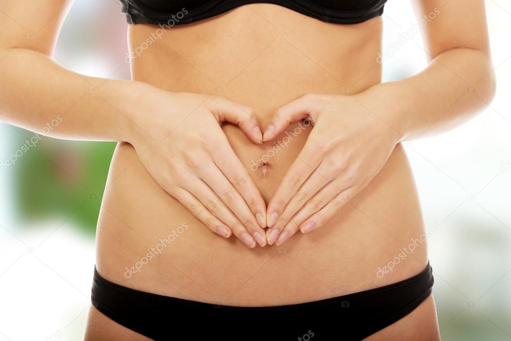 Woman with hands on belly.