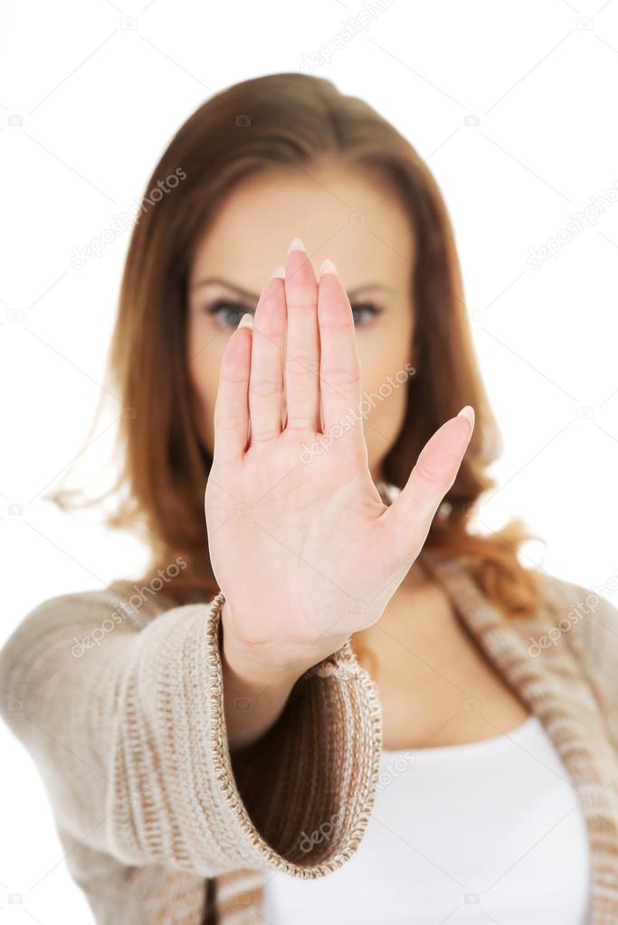 Casual woman making stop gesture.
