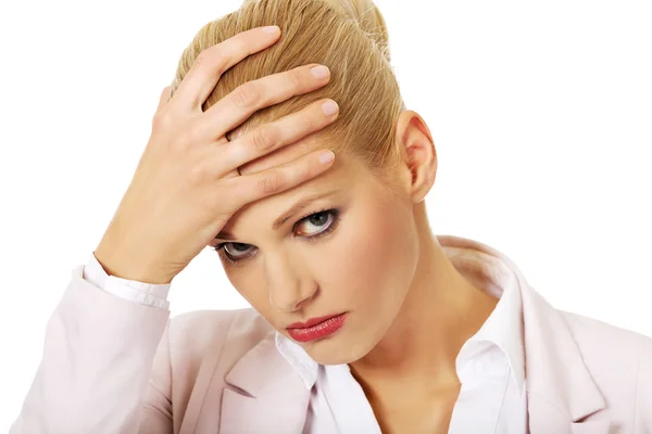 Business woman with a huge headache holding head — Stock Photo, Image