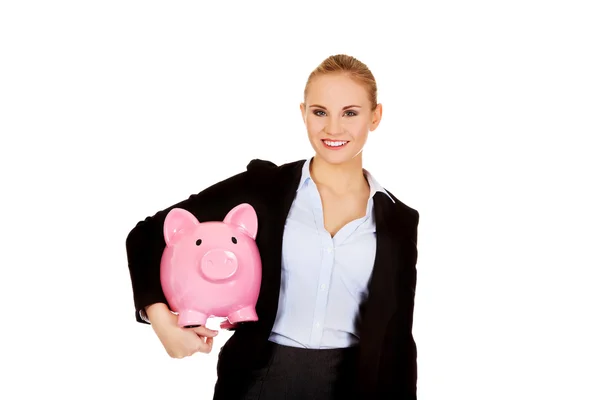 Jovem mulher de negócios segurando piggybank — Fotografia de Stock