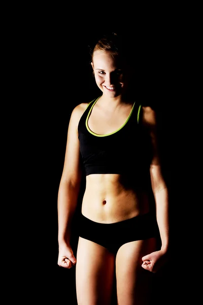 Young athletic woman in black sports underwear — Stock Photo, Image