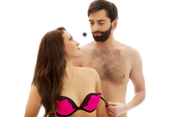 Men taking off womans bra. — Stock Photo, Image