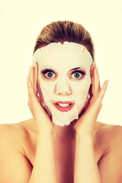 Mladá žena překvapená s obličejovou maskou — Stock fotografie