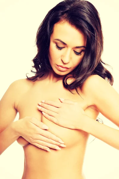 Beautiful topless woman examining her breast — Stock Photo, Image