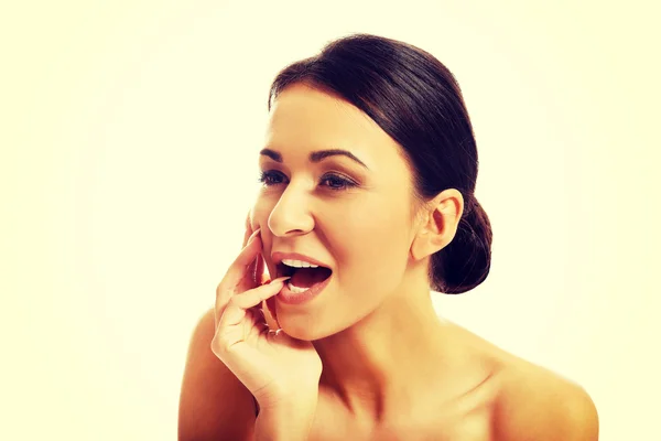 Happy beautiful woman holding finger in mouth — Stock Photo, Image