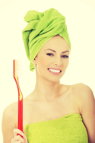 Beautiful woman with oversized toothbrush. — Stock Photo, Image