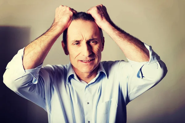 Portrait of frustrated man pulling his hair — Stock Photo, Image