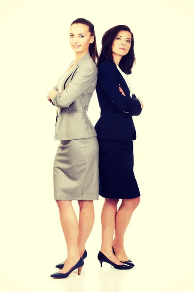 Two businesswoman leaning on each other. — Stock Photo, Image