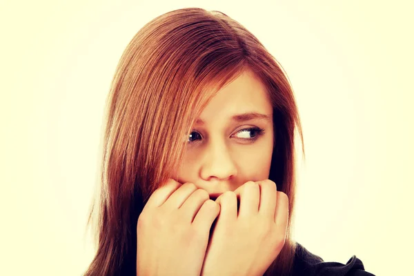 Stressed teenage woman biting nails — Stock Photo, Image