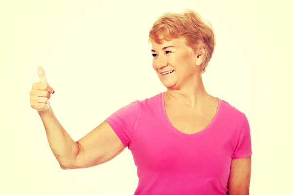 An old smilig woman with thumb up — Stock Photo, Image