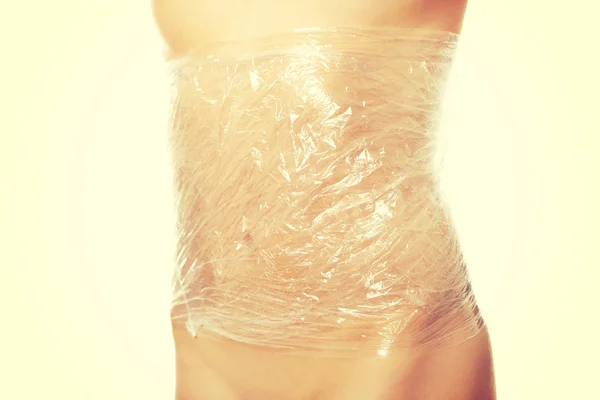 Young woman  wrapped in foil — Stock Photo, Image