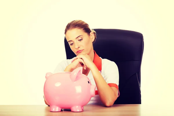 Female doctor holding a piggybank — Stock Photo, Image