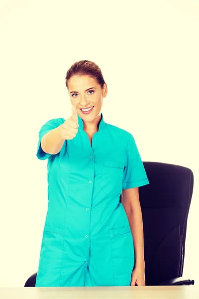 Ženský lékař směřují palec nahoru znamení — Stock fotografie