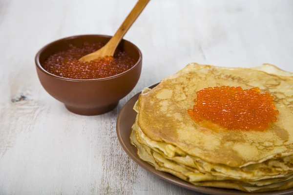 Pancakes with red caviar on a table — Stock Photo, Image