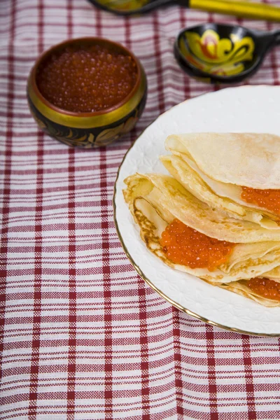 Delicious pancakes with red caviar on a table — Stock Photo, Image