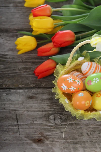 Bouquet of yellow and red tulips and easter eggs — Stock Photo, Image