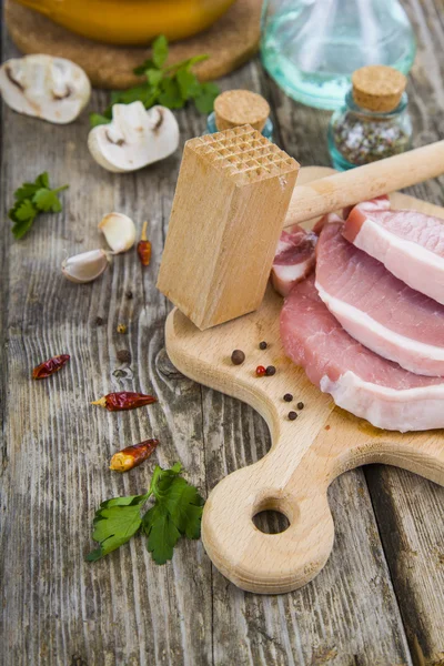 Raw meat on a wooden table — Stock Photo, Image
