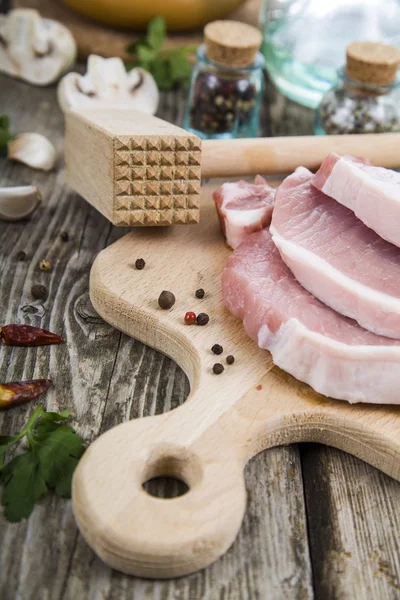 Raw meat on a wooden table — Stock Photo, Image