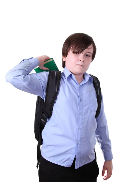 Schoolboy putting a book in a backpack — Stock Photo, Image