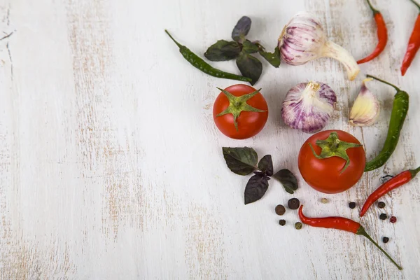 Vegetables and spices in a wooden table — Stock Photo, Image