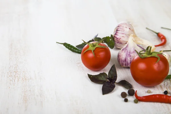 Vegetables and spices in a wooden table — Stock Photo, Image