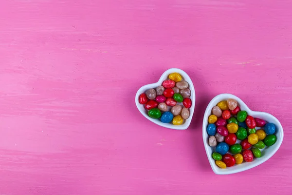 Pembe Ahşap Arka Planda Kalp Şeklinde Bir Tabakta Çok Renkli — Stok fotoğraf