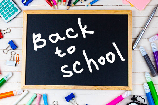 Various school supplies on a wooden table. Back to school. Stationery.