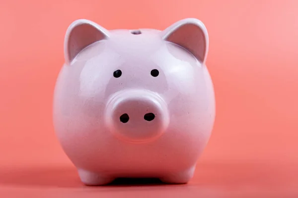 Pig piggy bank on a pink background. Money accumulation concept.