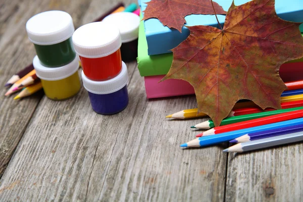 Books, pencils and maple leaf — Stock Photo, Image