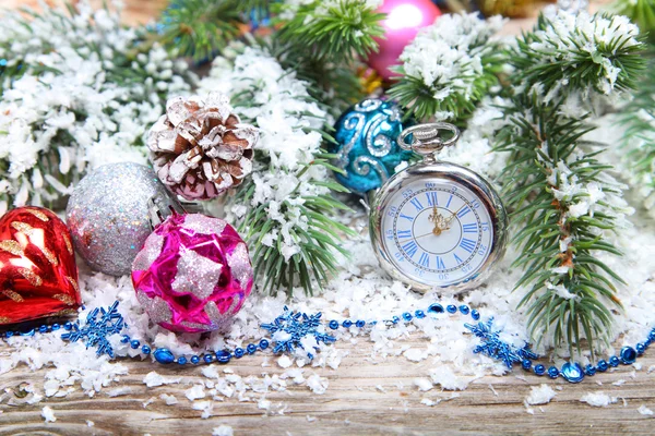 Christmas decorations and clock  in the snow — Stock Photo, Image