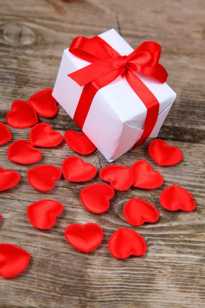 Holidays gift and red hearts — Stock Photo, Image